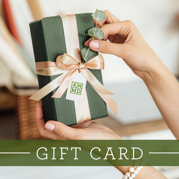 Hands holding a gift box with an Amy Myers MD® gift tag