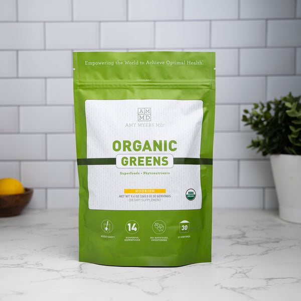 A bag of Organic Greens sitting on a granite countertop.