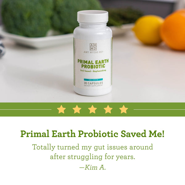 A bottle of Primal Earth Probiotic on table with reviews - Review Image - Amy Myers MD®