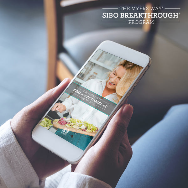 A Woman views The SIBO Breakthrough Program 30-day Guide on a smart phone - Amy Myers MD®
